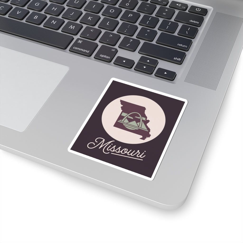 Missouri sticker decal on laptop, dark purple square with circular emblem and script