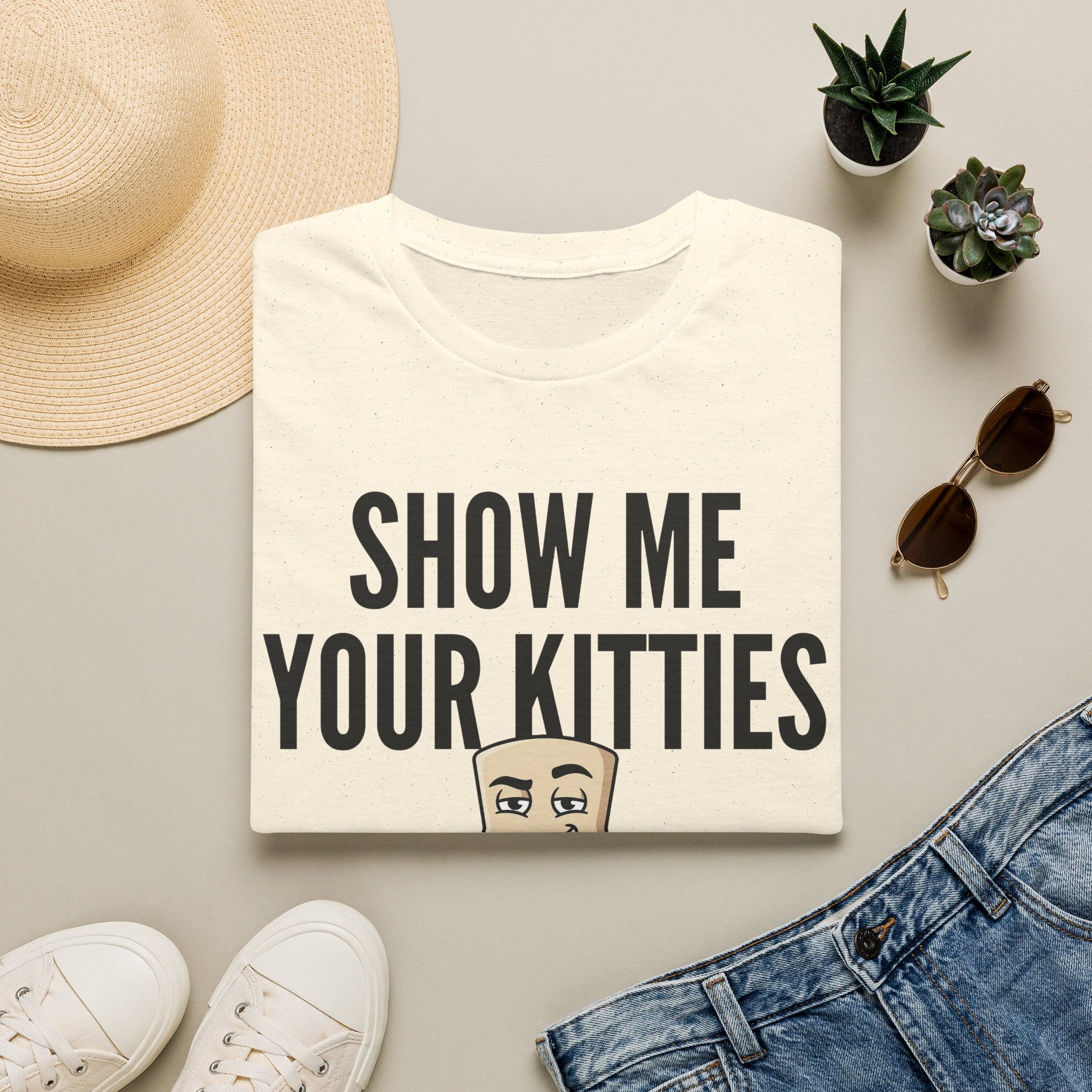 Off-white T-shirt with "SHOW ME YOUR KITTIES" text and cat graphic