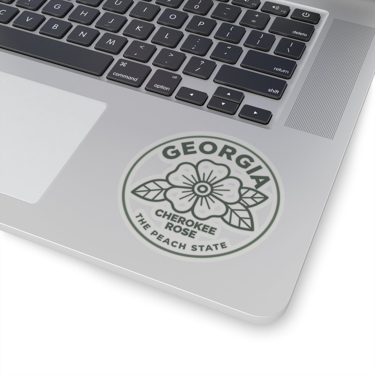 Circular Georgia decal with Cherokee Rose and The Peach State text on a laptop