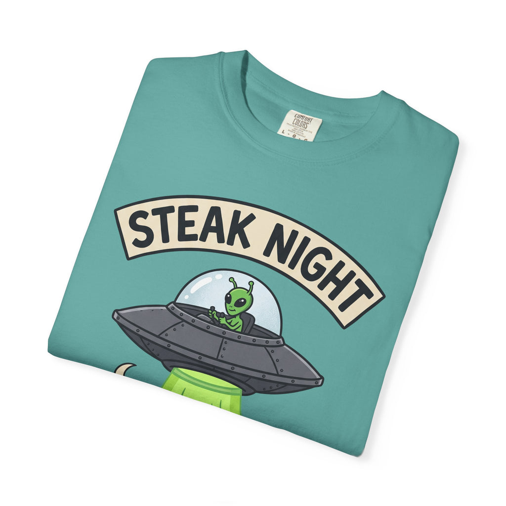Teal graphic T-shirt with 'STEAK NIGHT' UFO and alien cow illustration.