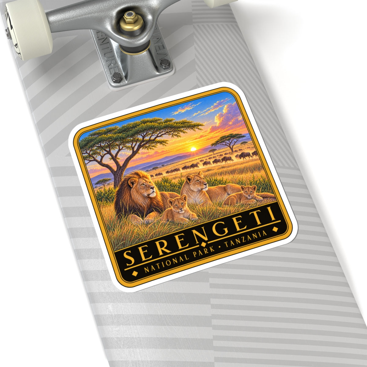 Serengeti kiss-cut vinyl decal on a paper sheet: lions at sunset, black-gold framed design
