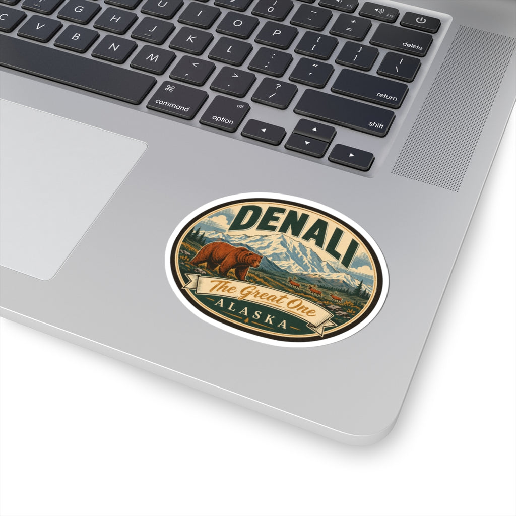 Denali oval sticker on a silver laptop lid, bear, mountains, and “The Great One Alaska” graphic