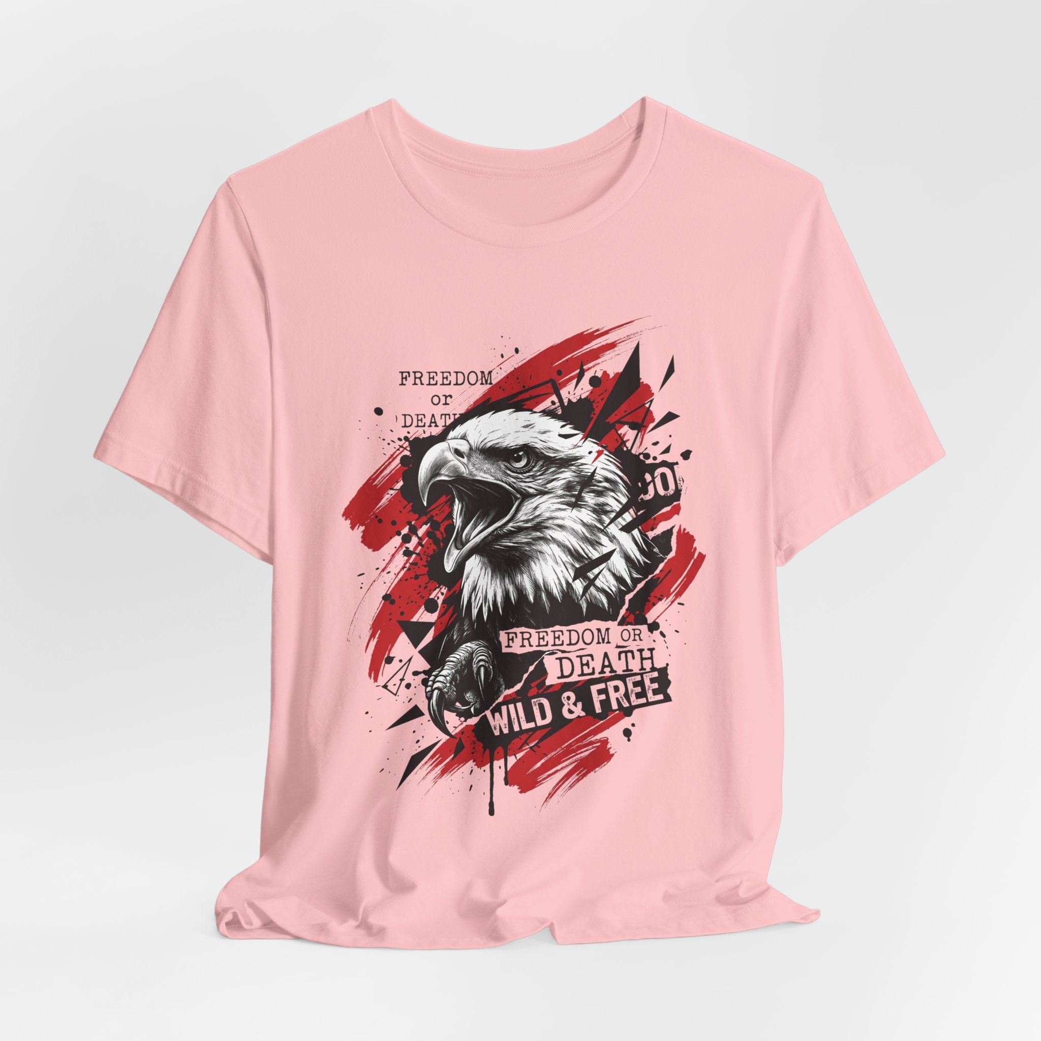 Blush pink T-shirt with bald eagle graphic, red splashes and text slogan