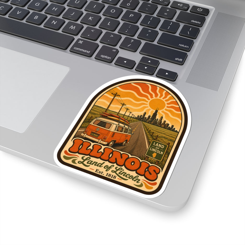 Kiss-cut sticker on laptop: orange camper van and skyline with Illinois lettering and Land of Lincoln
