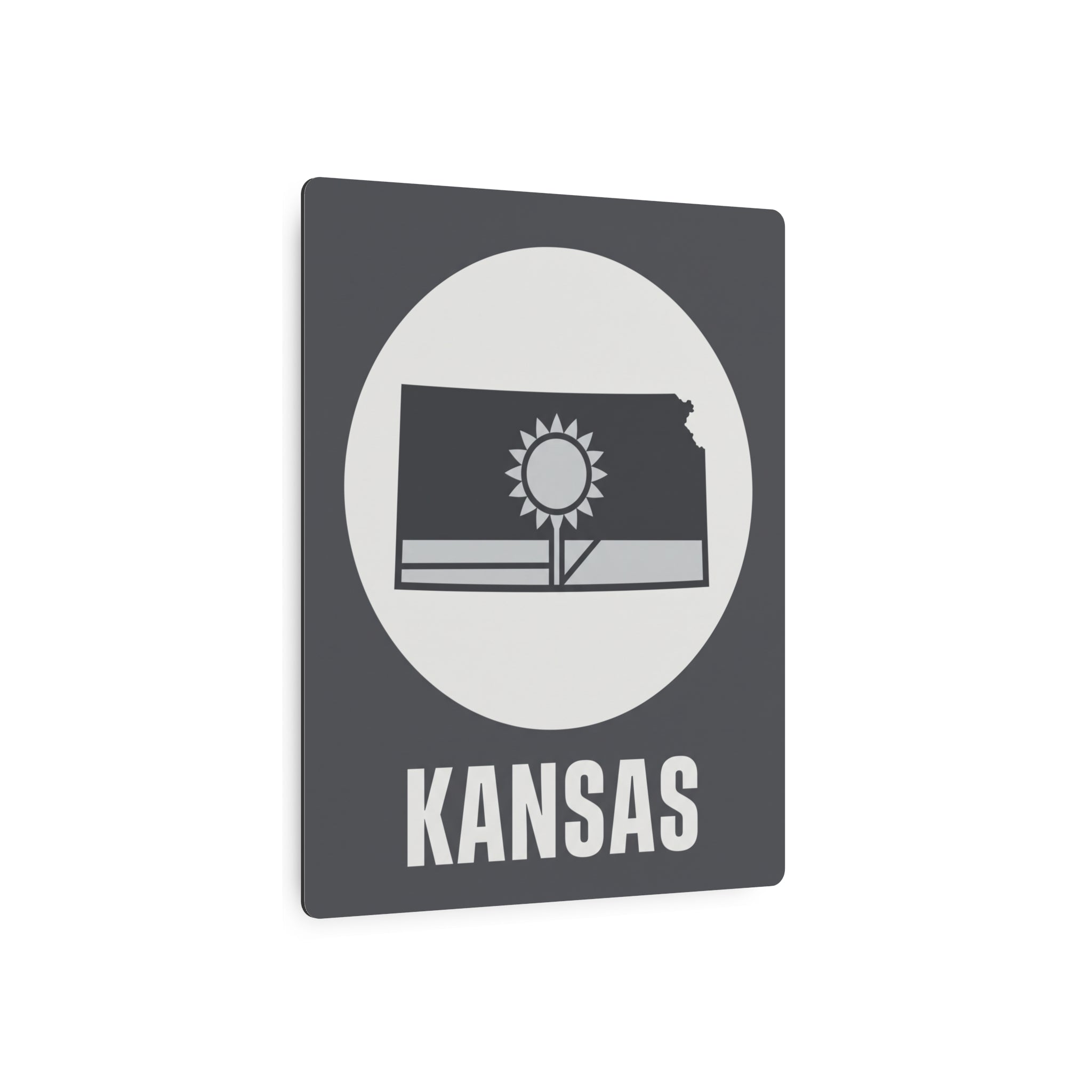 Dark gray metal Kansas wall sign with circular sunburst, Kansas outline, and 'KANSAS' text