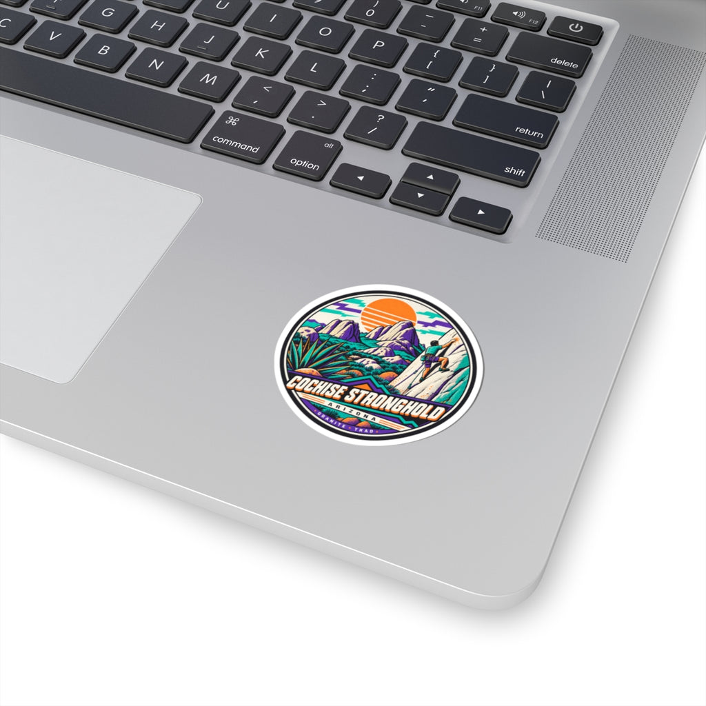 Round climbing sticker with colorful mountain and climber graphic on a laptop