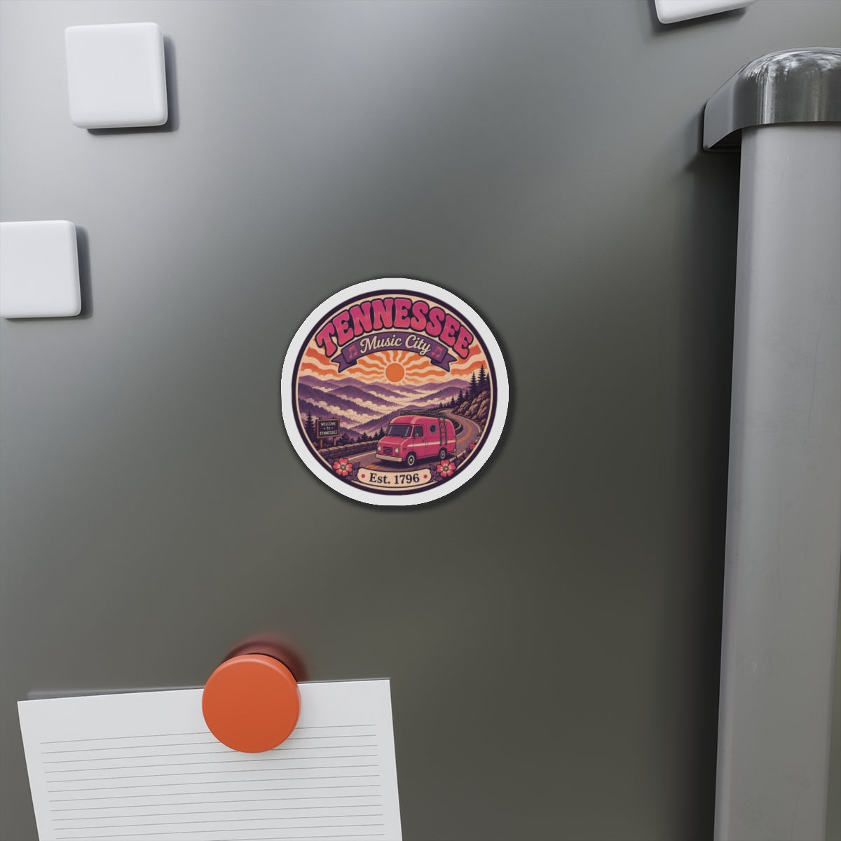 Tennessee Music City magnet attached to refrigerator door, circular design with retro van and Est. 1796.
