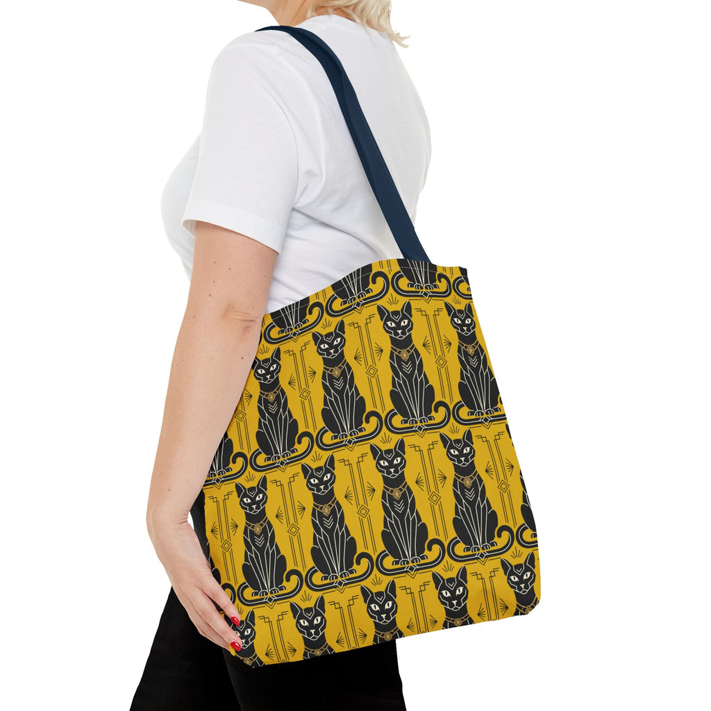 Yellow tote bag with black cat pattern and navy strap over shoulder
