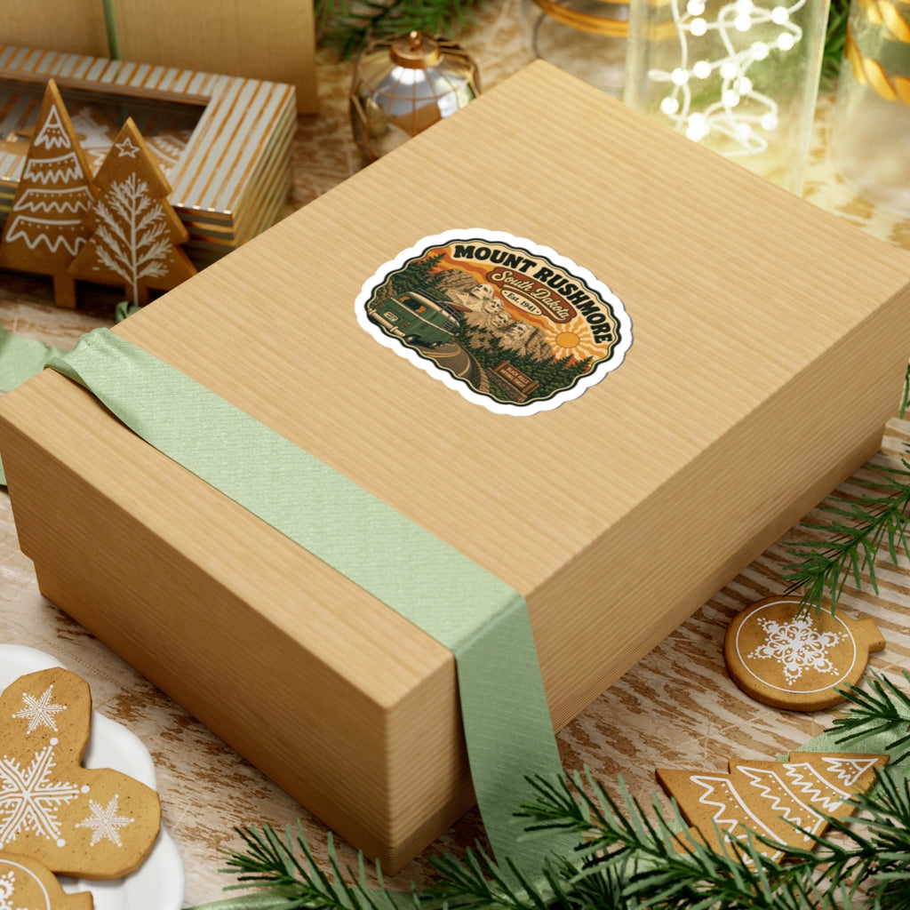Die-cut sticker on gift box top, featuring Mount Rushmore, South Dakota, and green van