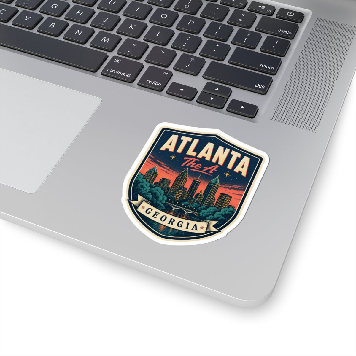 Atlanta Georgia luggage tag sticker on laptop lid, blue shield with city skyline