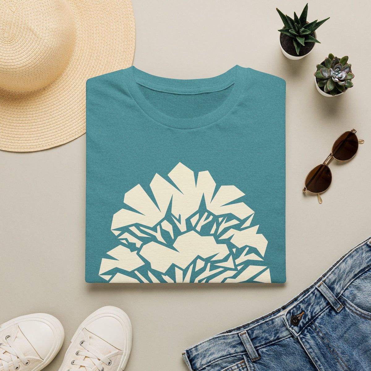 Teal t-shirt with geometric faceted tree silhouette graphic on front.