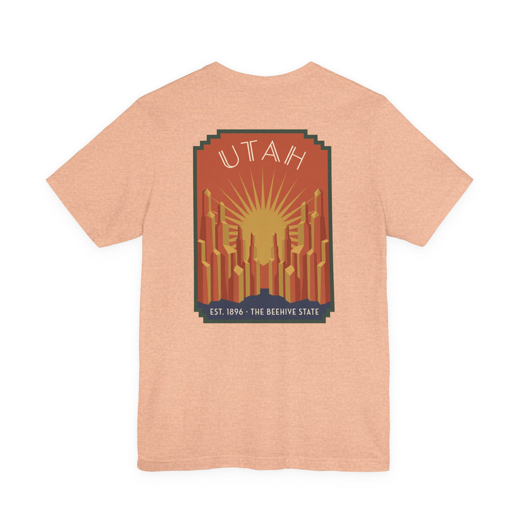 Light peach T-shirt with Utah sunrise art deco square graphic, UTAH text and skyline
