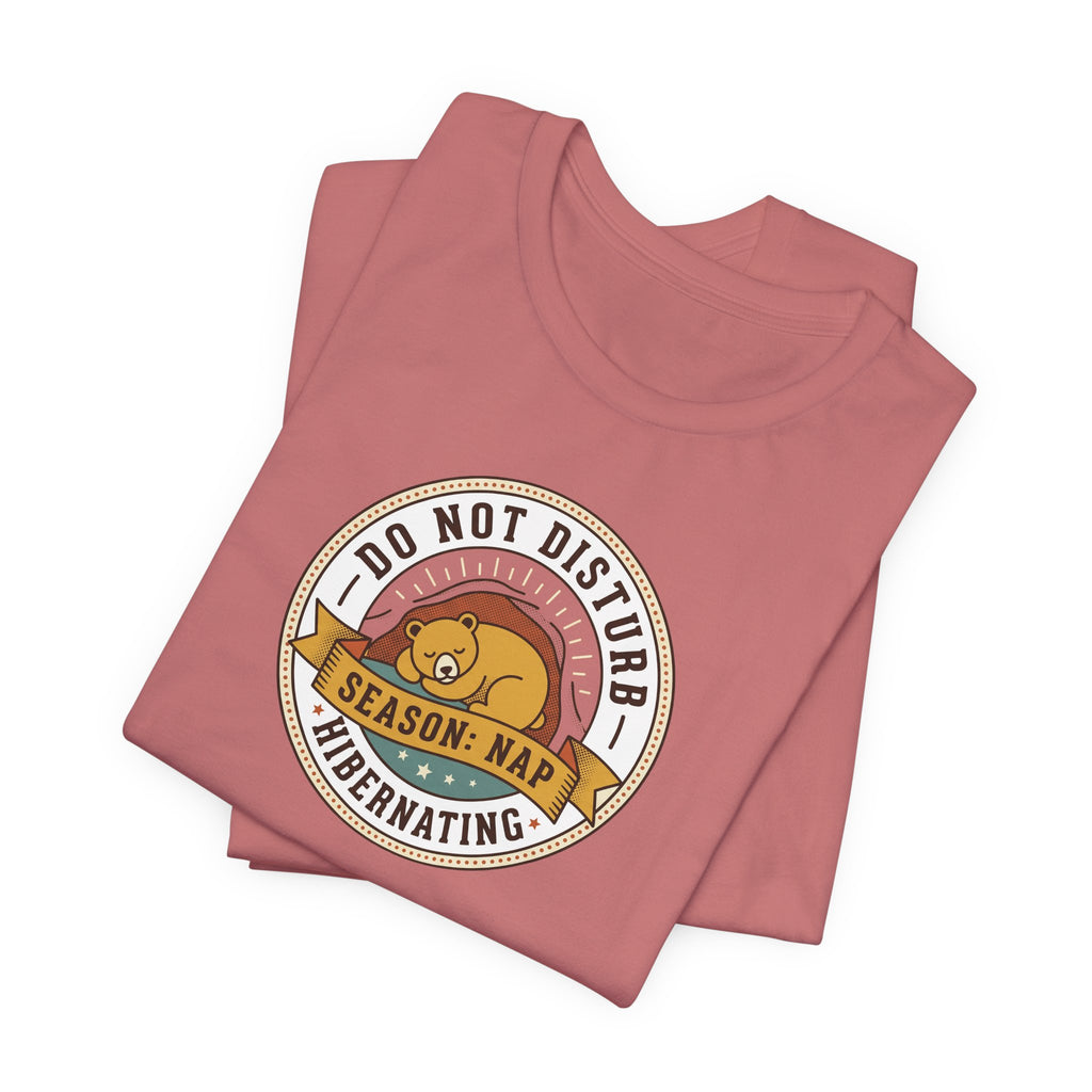 Mauve T-shirt with round bear sleeping badge graphic on chest