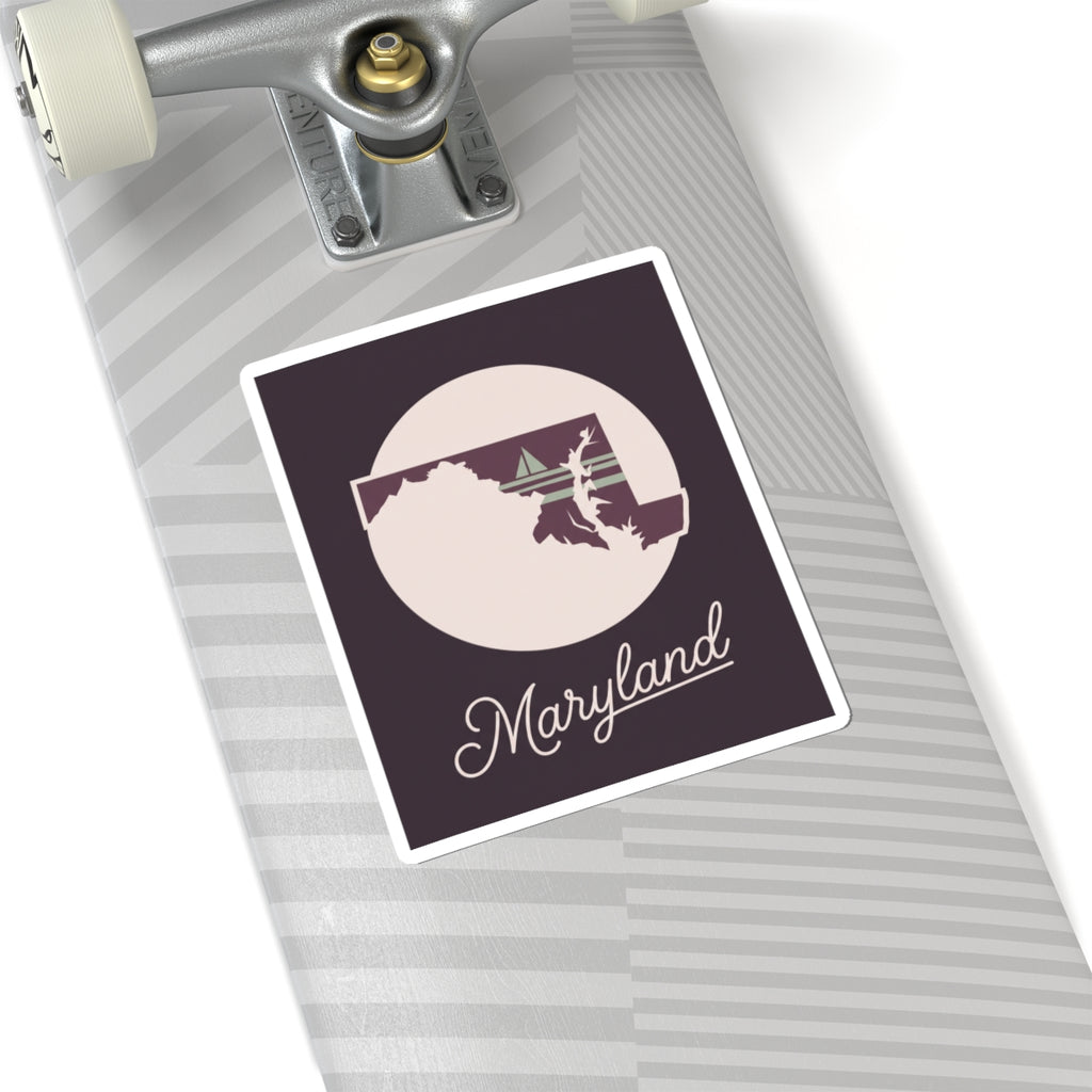 Maryland state silhouette vinyl sticker: circular badge, mauve background, and “Maryland” script