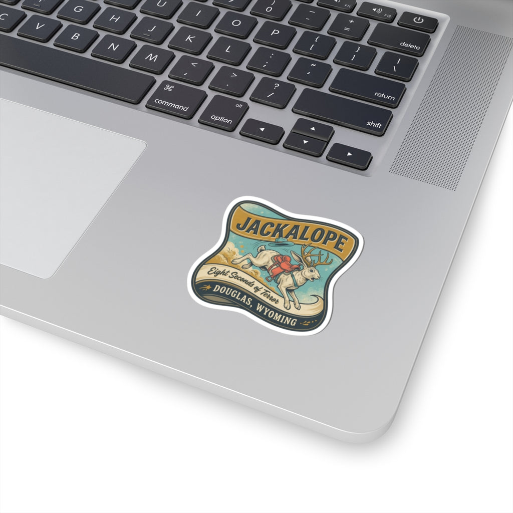Die-cut JACKALOPE logo sticker with colorful illustration, on laptop keyboard