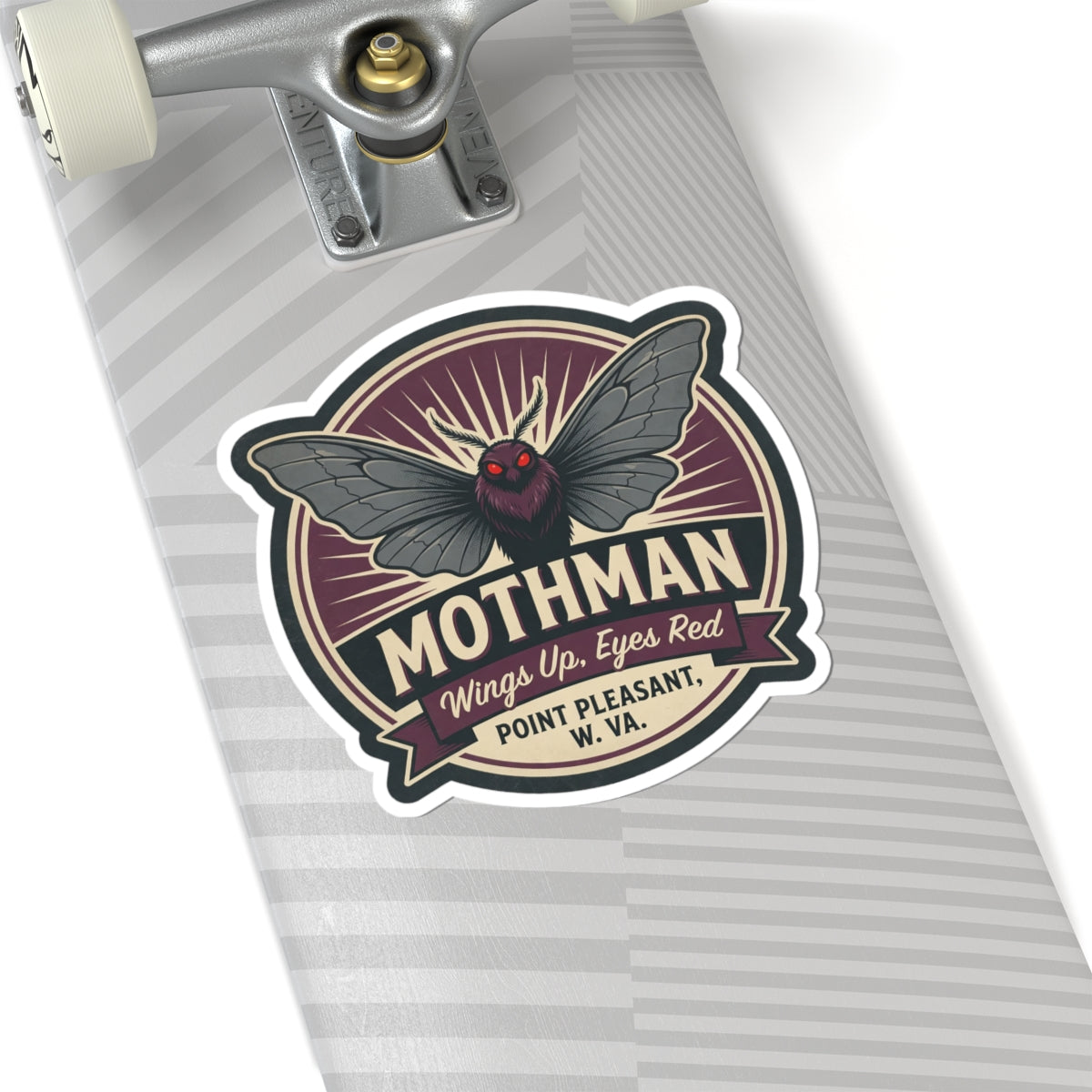 Mothman emblem kiss-cut sticker on striped paper, round badge with red eyes and wings