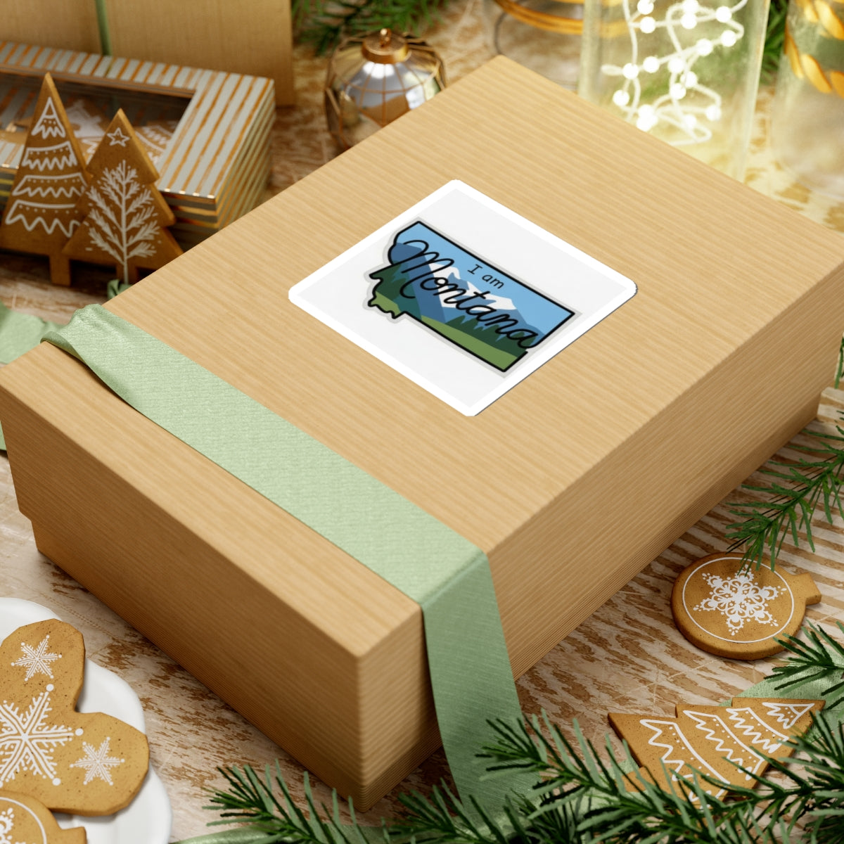 I am Montana sticker on wrapped gift box, blue sky mountains with cursive text