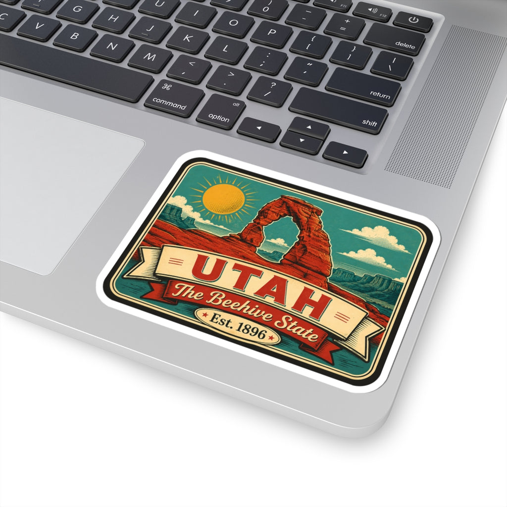 Utah retro vinyl sticker with red Delicate Arch, sun, and Est. 1896 on laptop