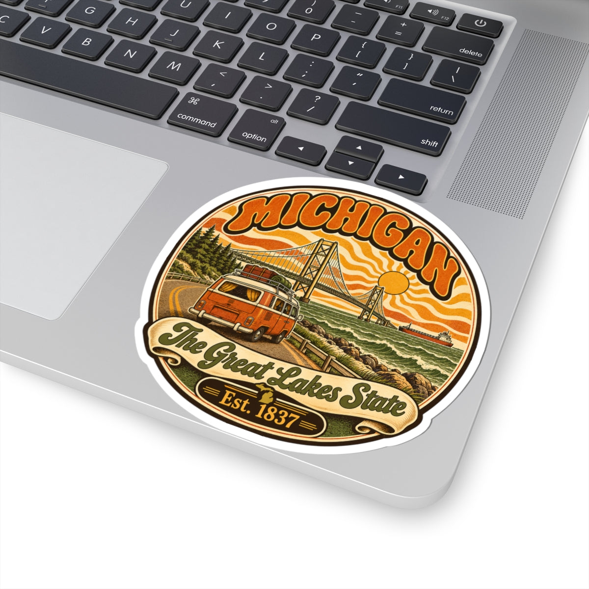 Michigan sticker featuring orange camper, bridge, waves, “The Great Lakes State,” Est. 1837