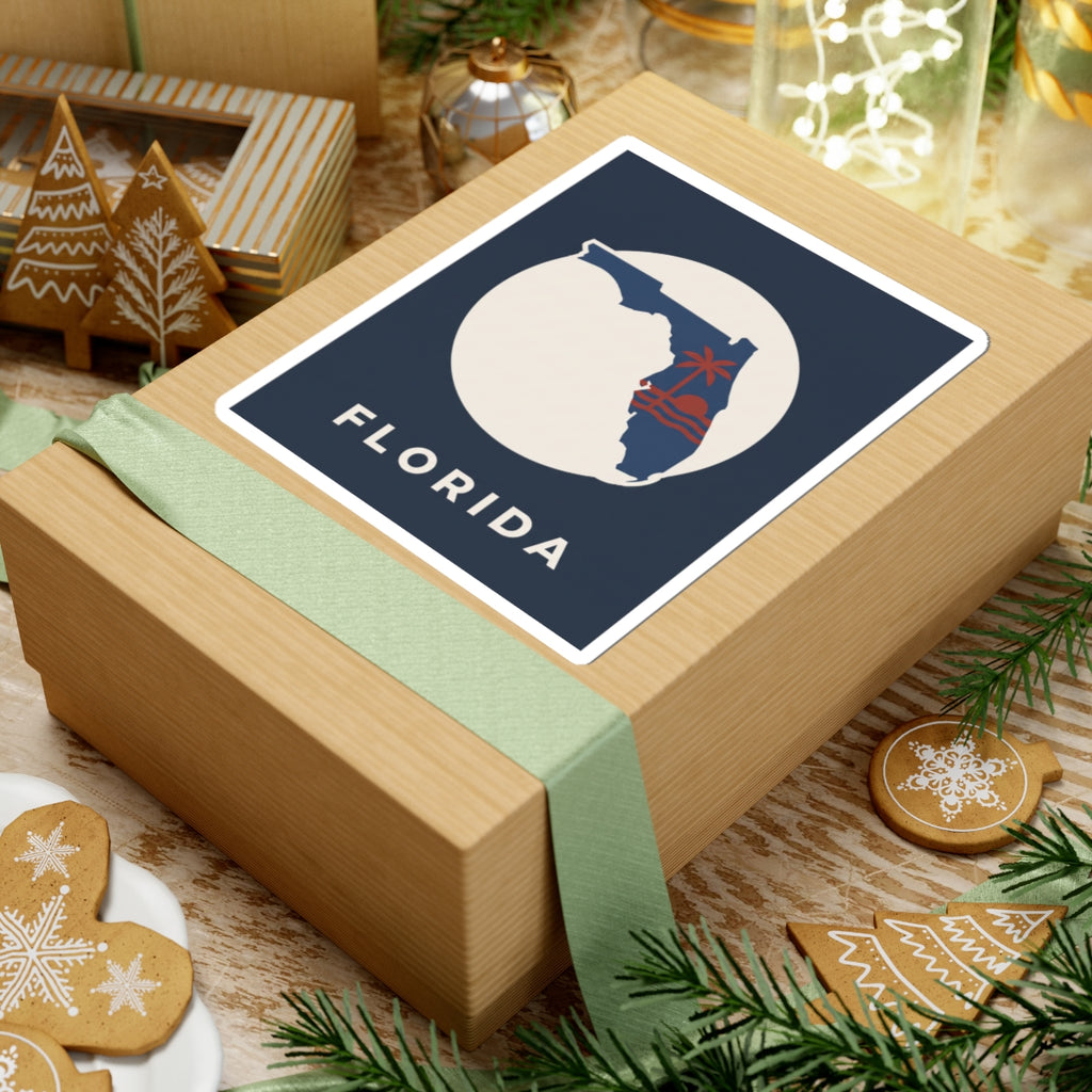 Florida sticker on gift wrap: blue square with white circle, red palm tree, FLORIDA text