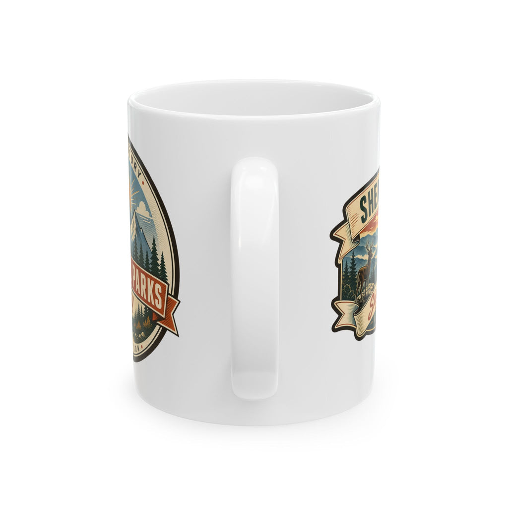 White ceramic mug with landscape badge decal and molded side handle grip.