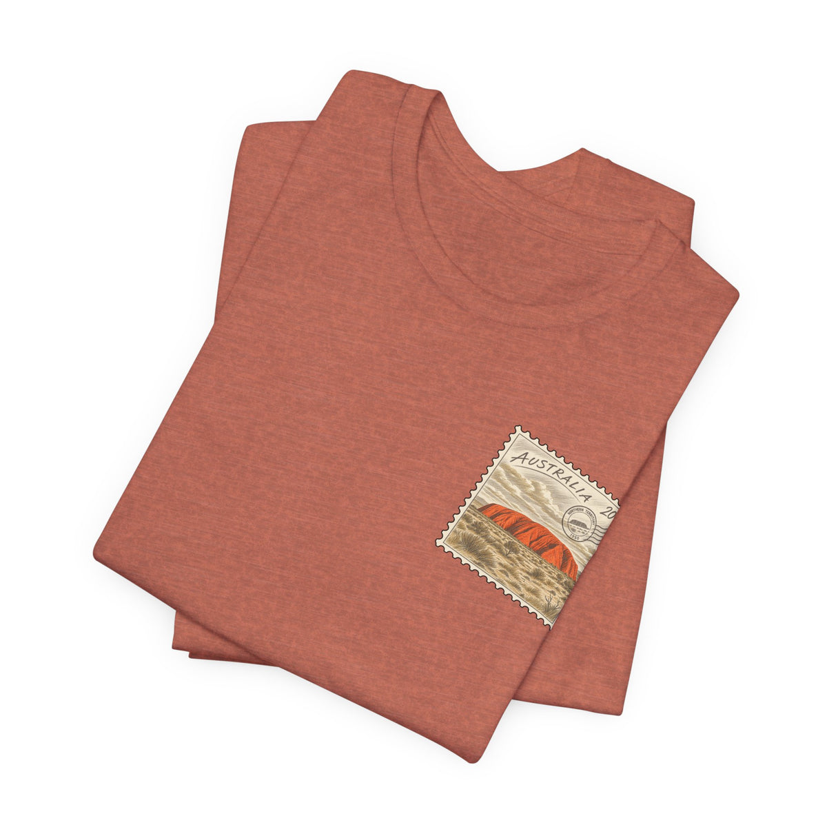 Rust red T-shirt with small Australia postage-stamp graphic on chest, folded view