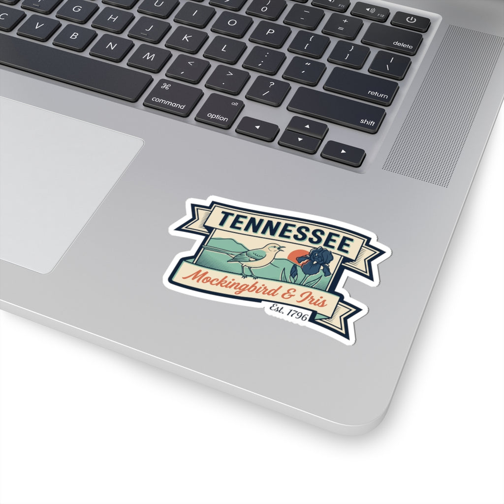 Tennessee vinyl sticker on a laptop lid, featuring mockingbird and iris badge