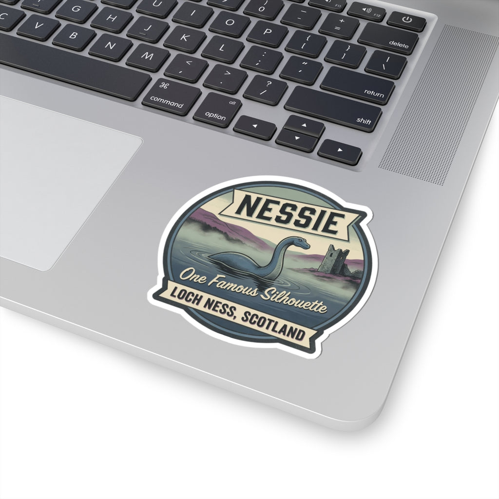 Nessie sticker badge on a laptop keyboard with “One Famous Silhouette” and “Loch Ness, Scotland”