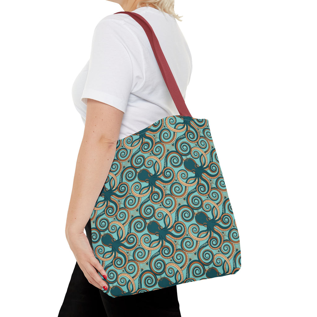 Teal octopus swirl tote bag with red strap, side view