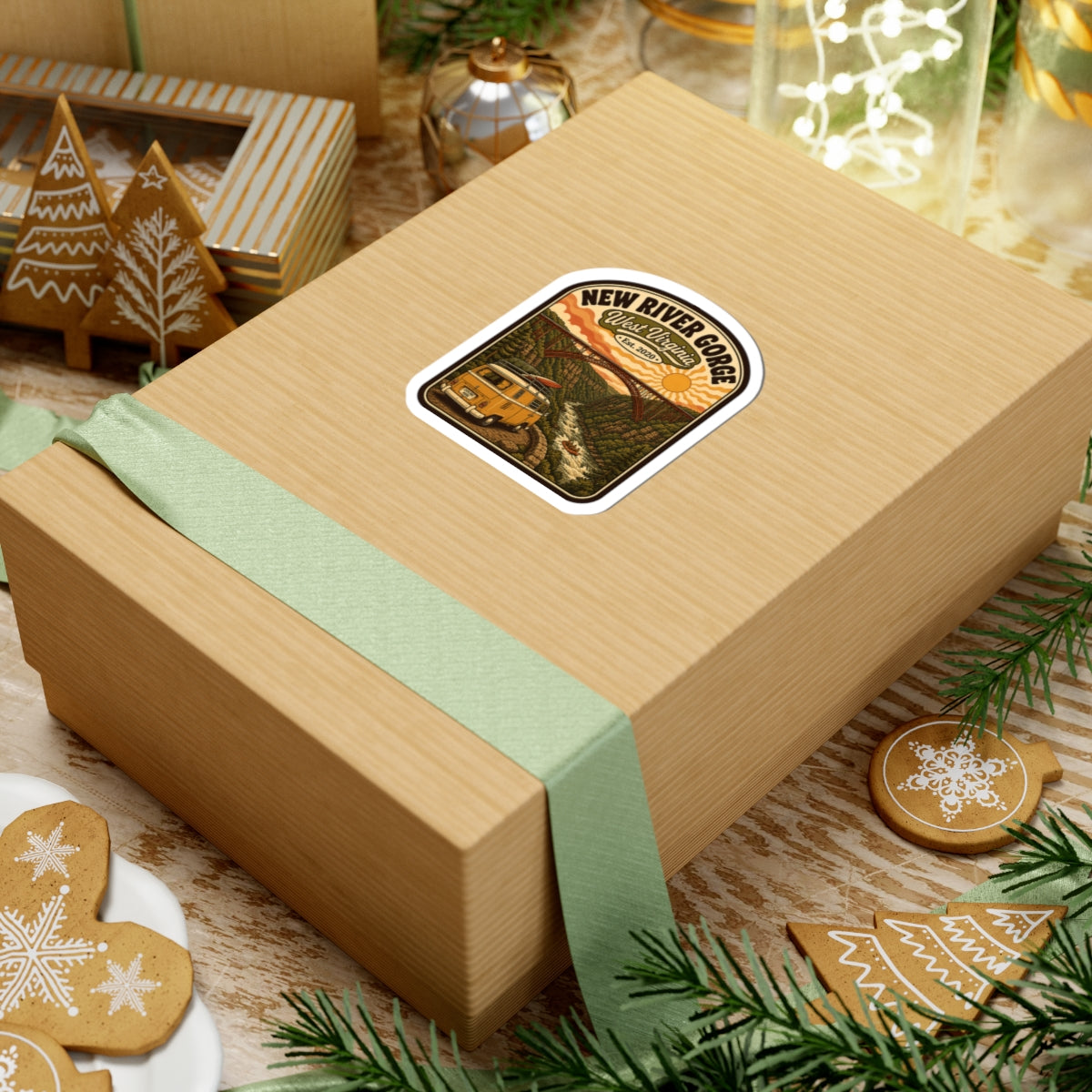 Rounded kiss-cut sticker on a gift box, New River Gorge logo with yellow van