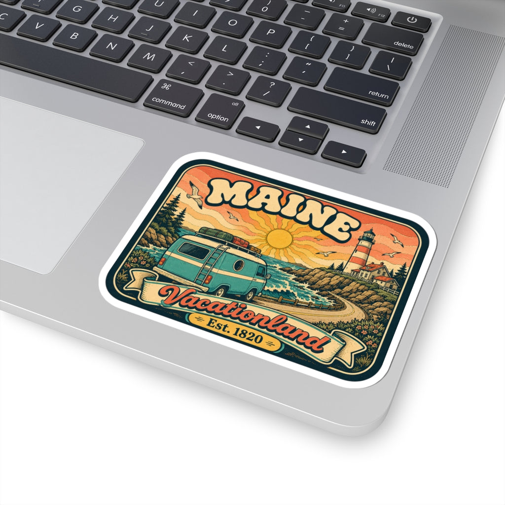 Maine Vacationland sticker on laptop keyboard, with teal van and lighthouse artwork