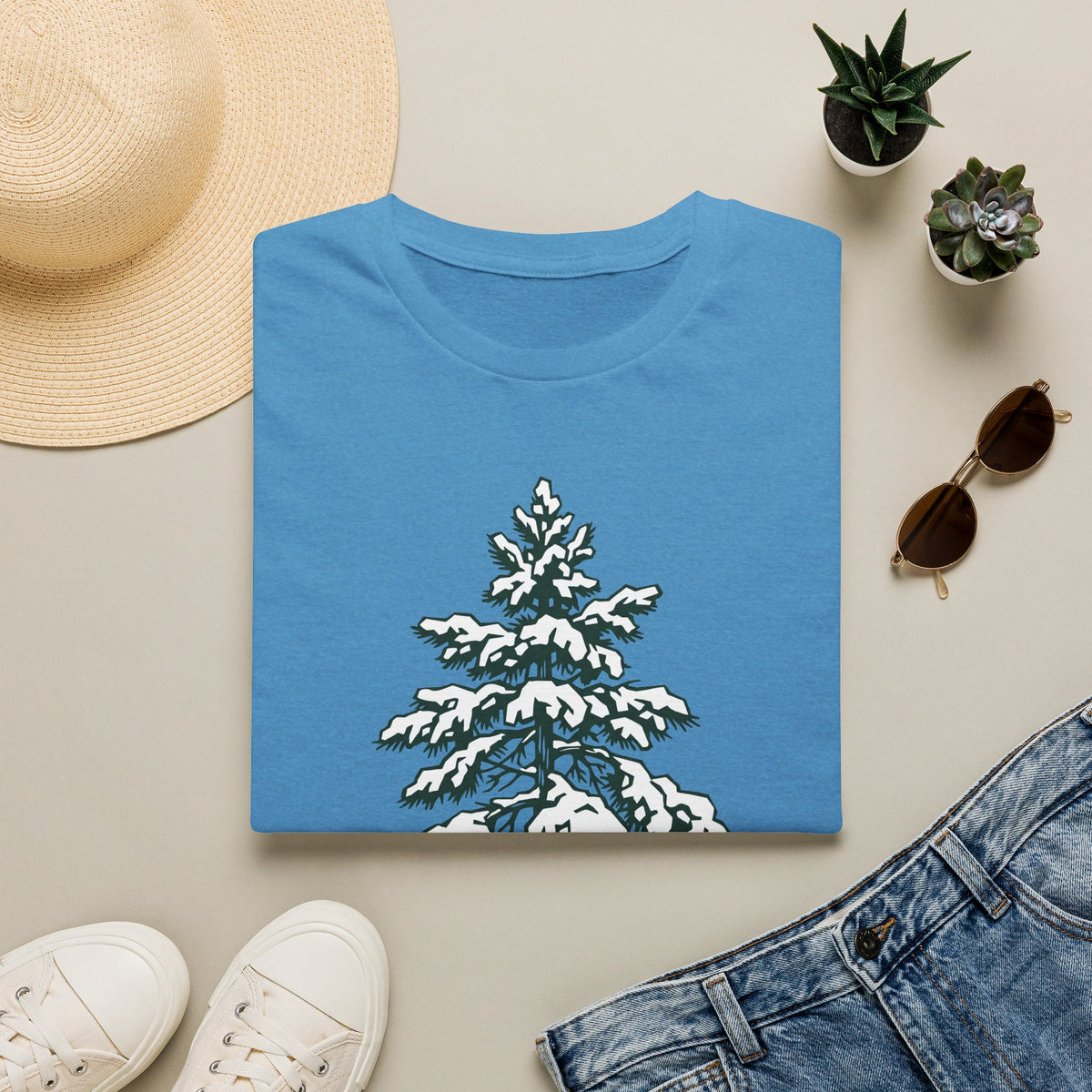 Blue crew-neck t-shirt with snowy pine tree graphic on the front