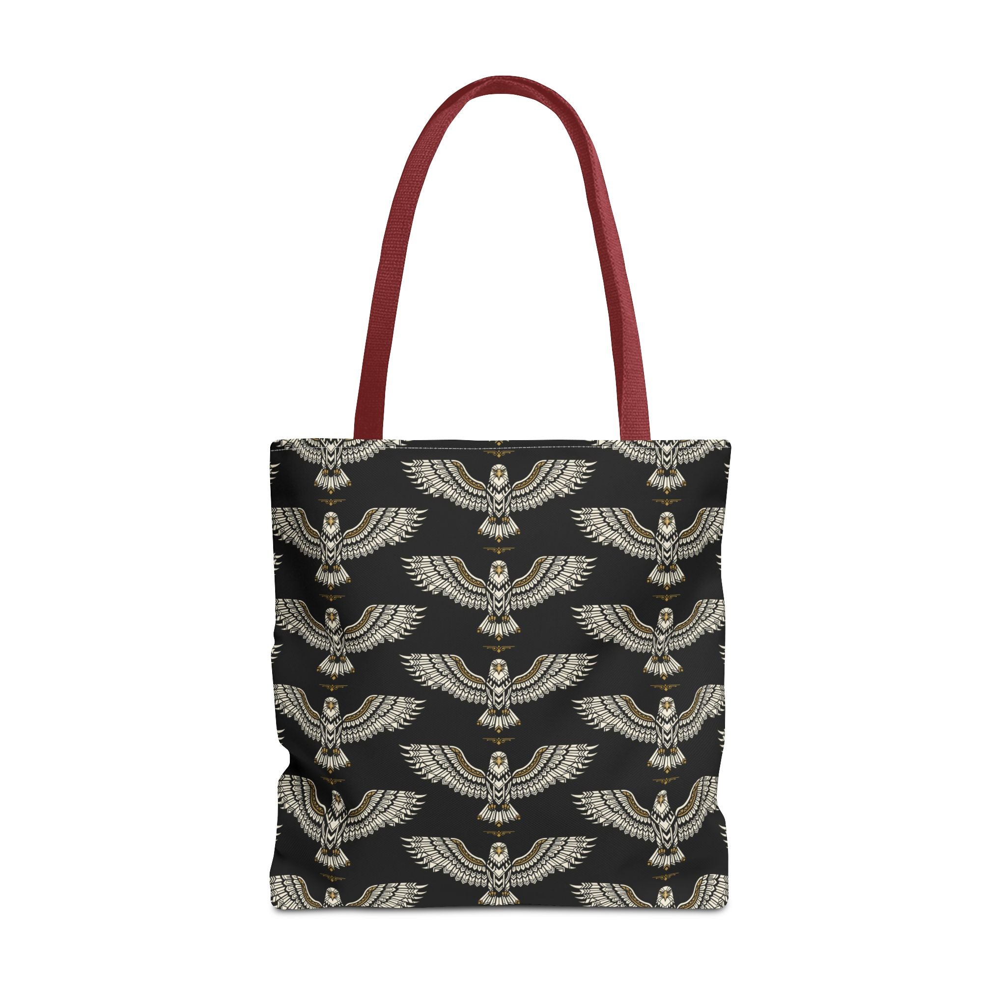 Tote bag with black fabric and repeating gold winged scarab pattern, red handles