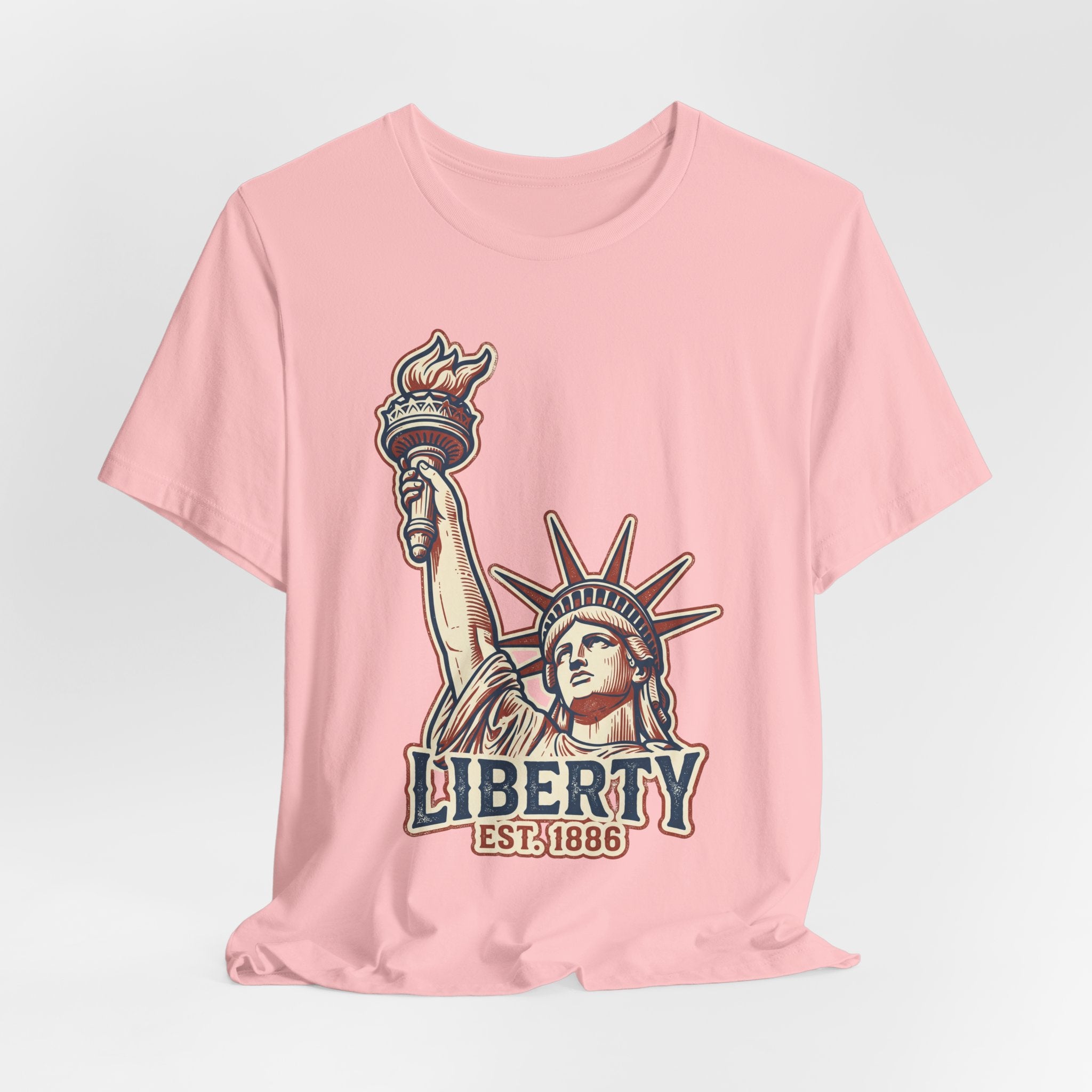 Light pink graphic tee with Liberty Statue illustration and LIBERTY EST. 1886