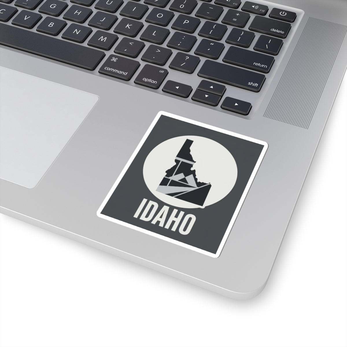 Idaho geometric map kiss-cut sticker, dark square with white circle, Idaho outline over mountain lines