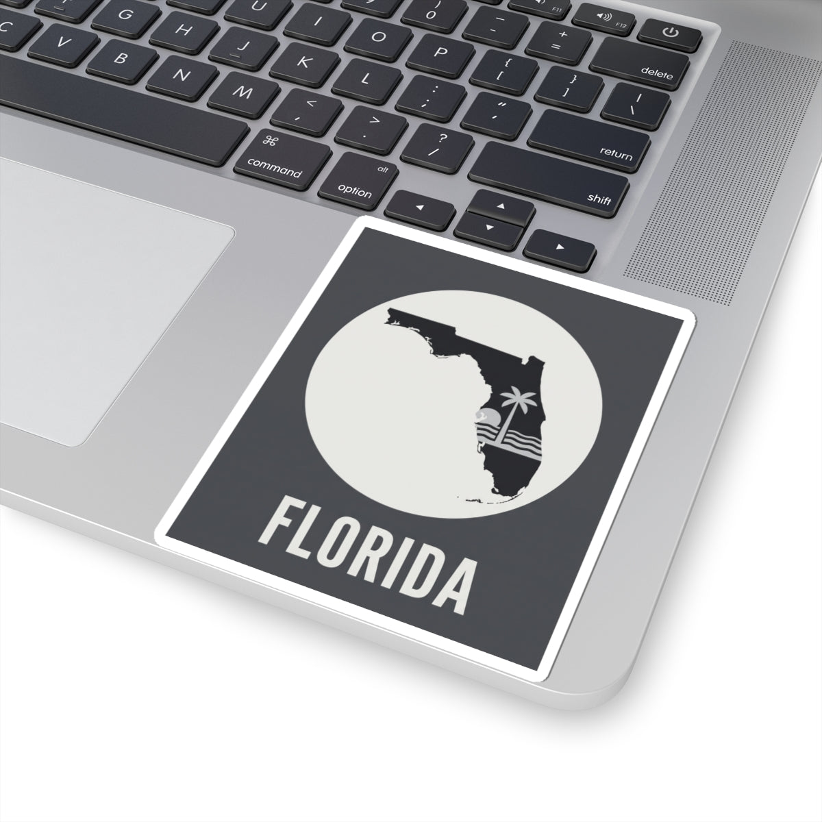 Florida silhouette kiss-cut sticker on laptop, circular palm wave design and FLORIDA lettering
