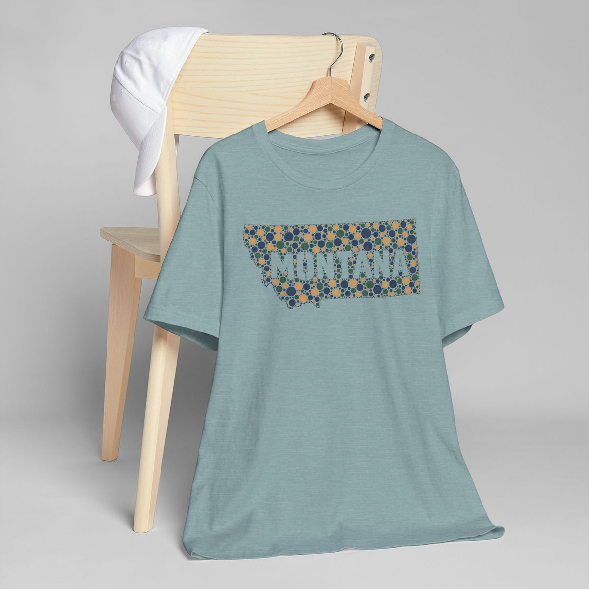 Light blue T-shirt with colorful dotted Montana graphic on chest.