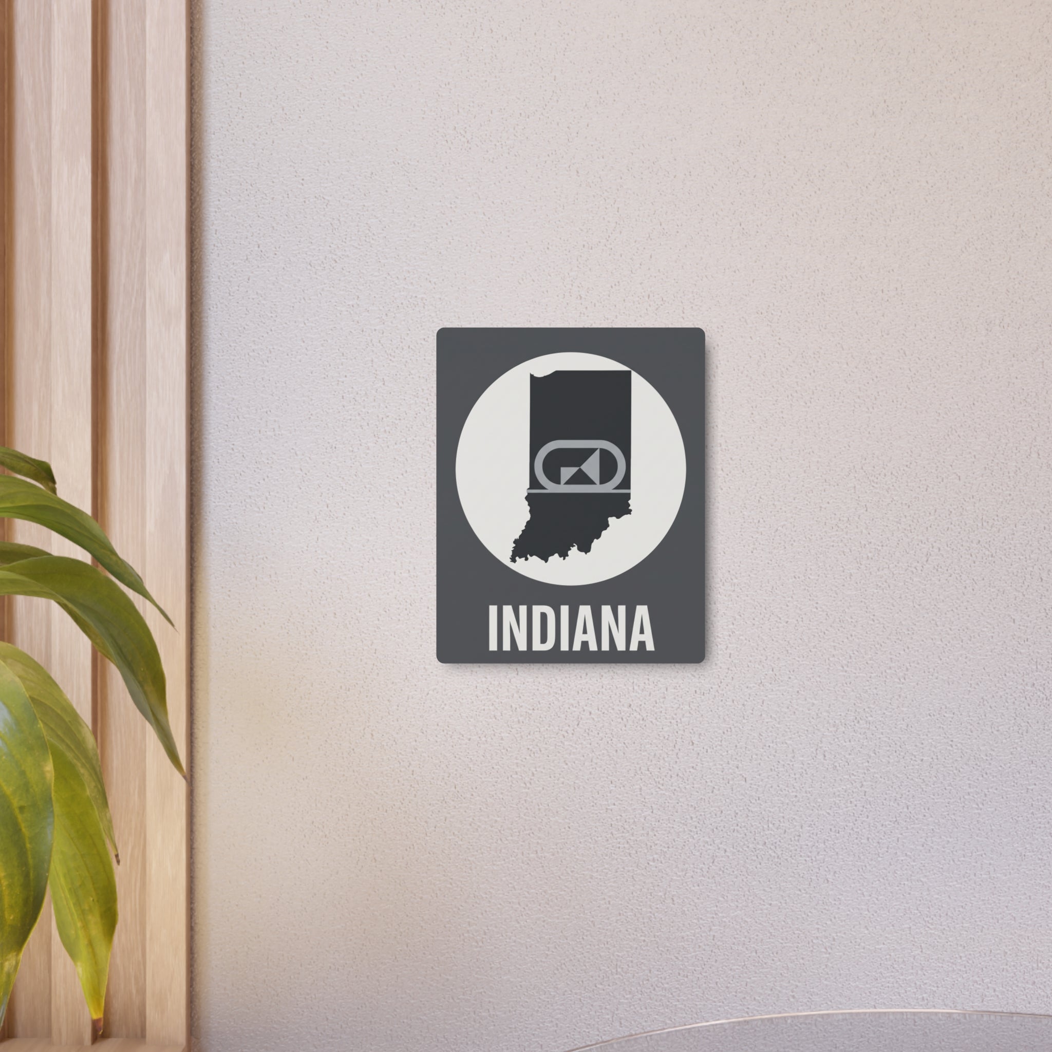 Indiana metal wall art mounted on wall with retro camera icon and “INDIANA” lettering