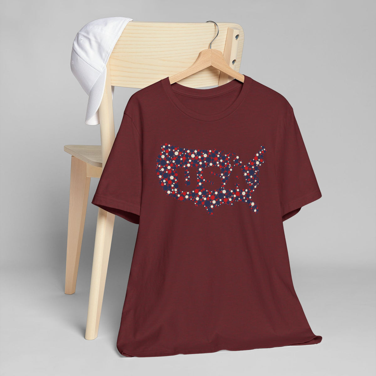 Maroon crew-neck T-shirt with dotted U.S. map graphic in red, blue, and white.