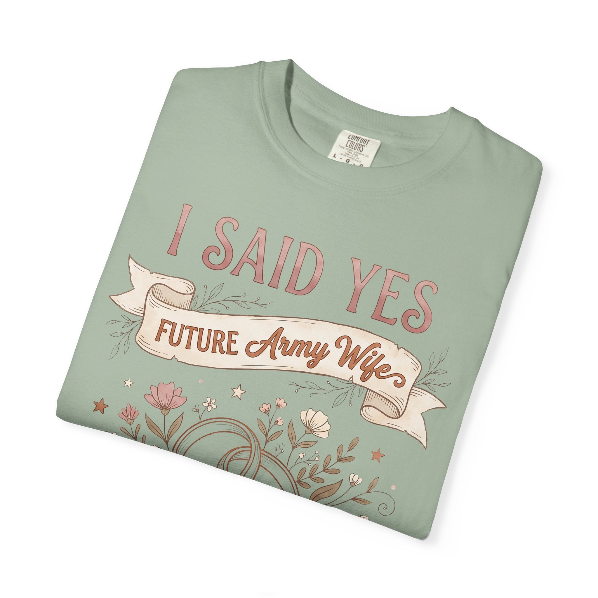 Light green T-shirt with floral ribbon graphic and text design on front.