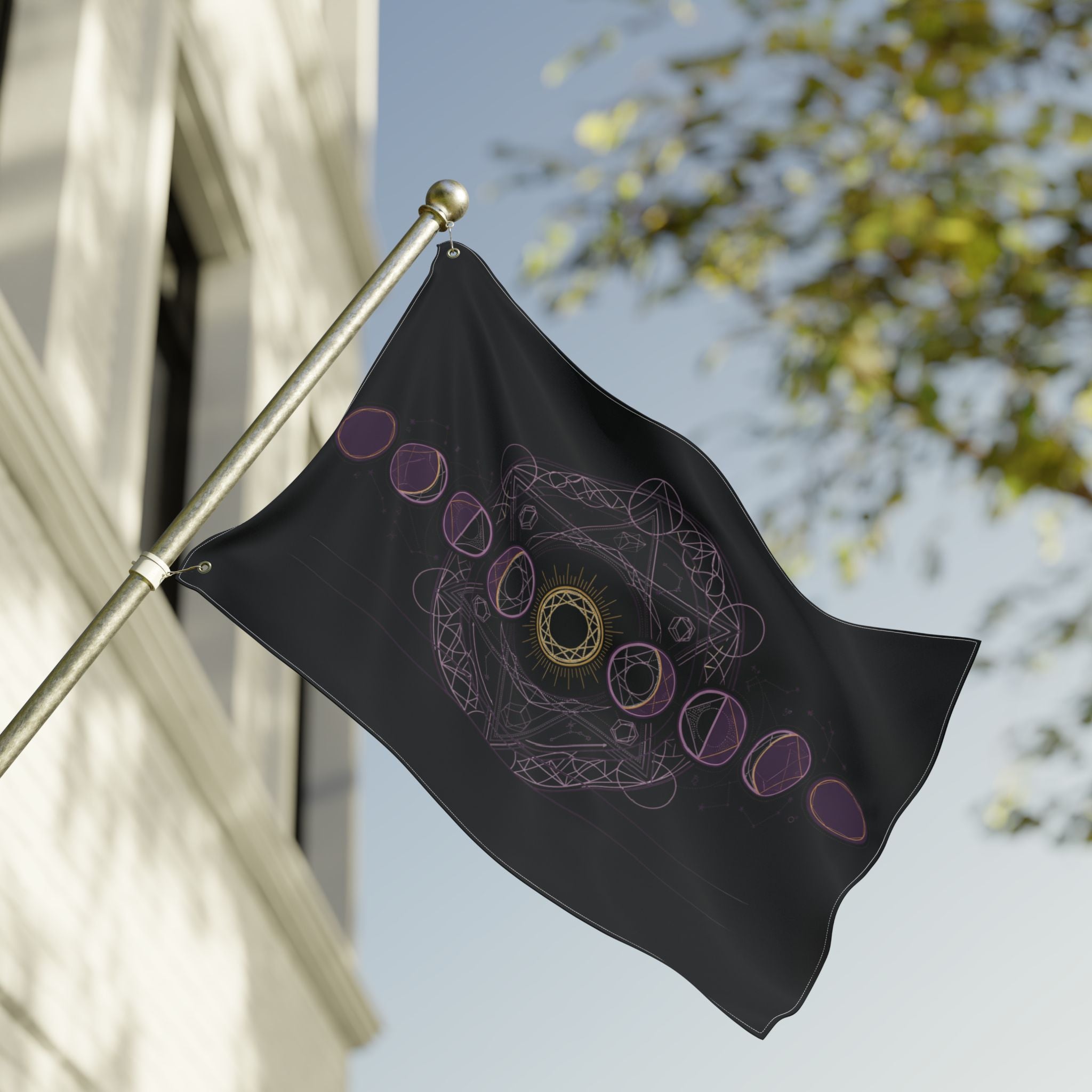 Black moon-phase flag close-up on pole, purple rings and gold mandala centered on fabric.