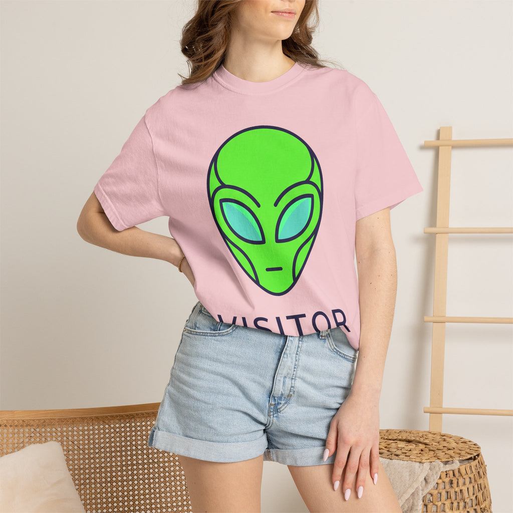 Light pink crew-neck alien face graphic T-shirt with partial dark text, short sleeves