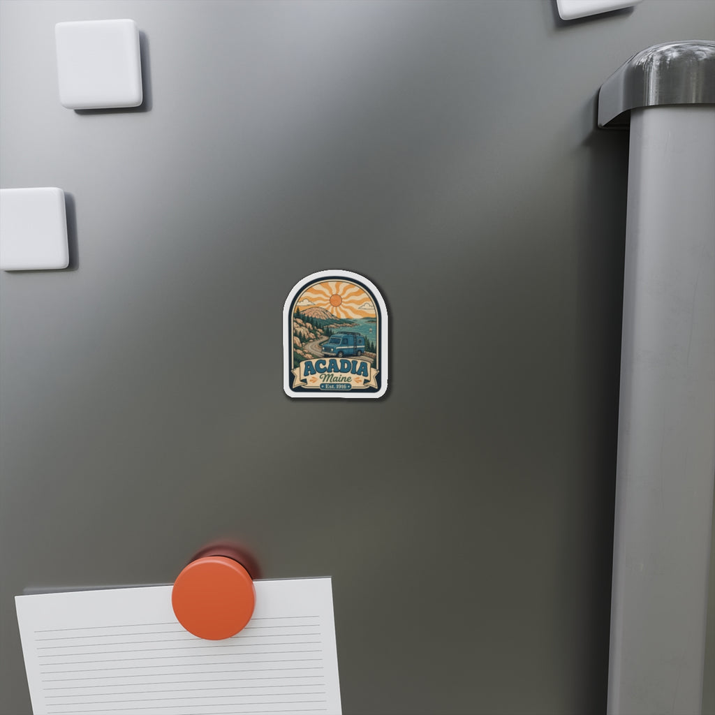 Die-cut Acadia Maine magnet on a stainless fridge with vintage camper scenery and Est. 1916
