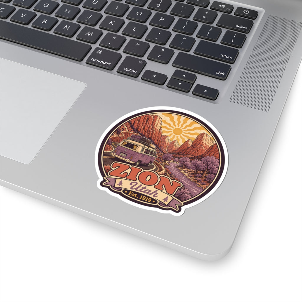 Zion Utah sticker with purple camper van driving a road through red canyon scenery and sun rays