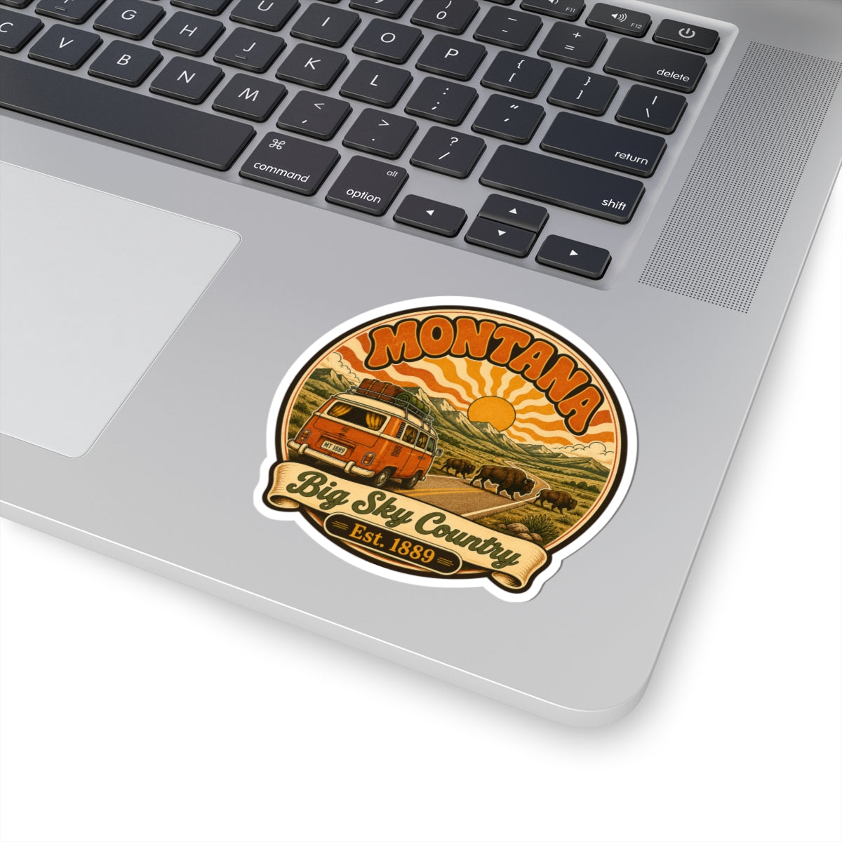 Round vintage camper sticker with buffalo, orange sun, and 'Big Sky Country' banner