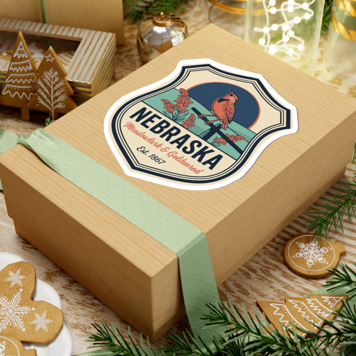 Nebraska badge sticker on a wrapped gift box, meadowlark & goldenrod text, Est. 1867