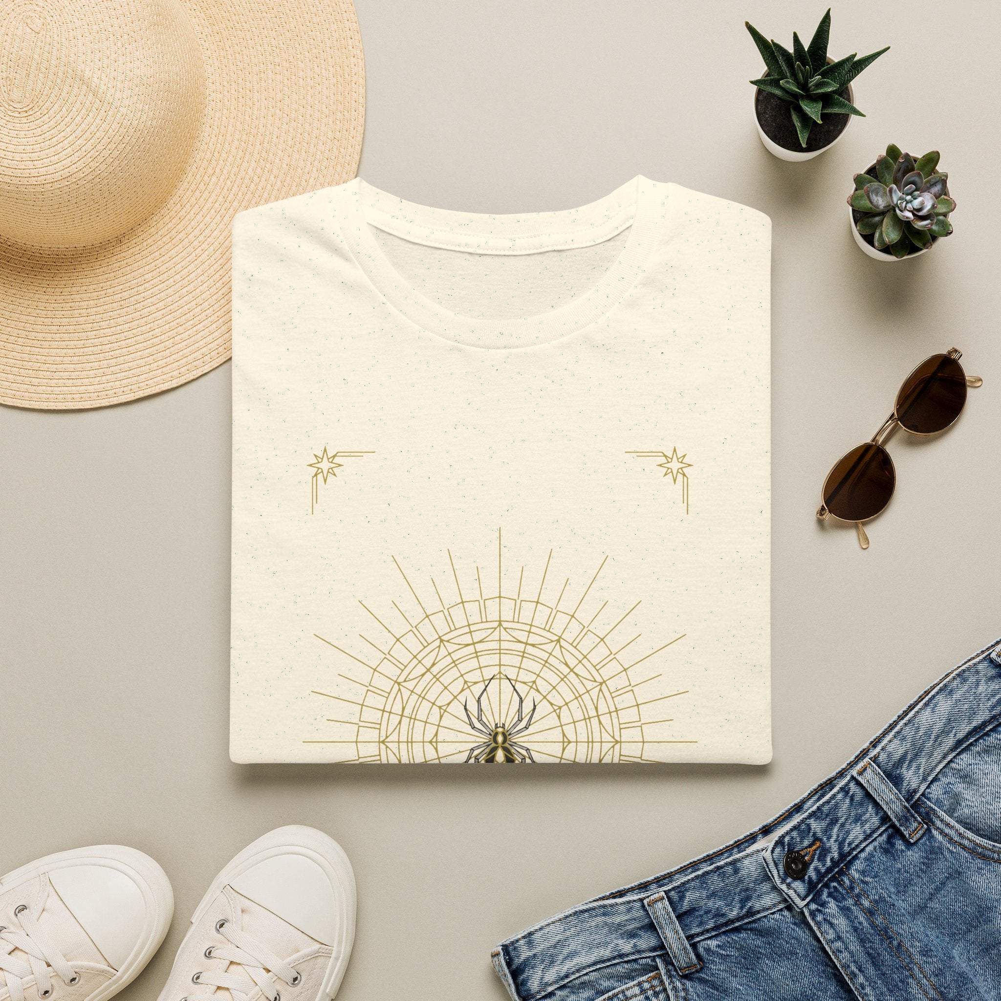 Off-white T-shirt with light gold spider mandala web and small star graphic