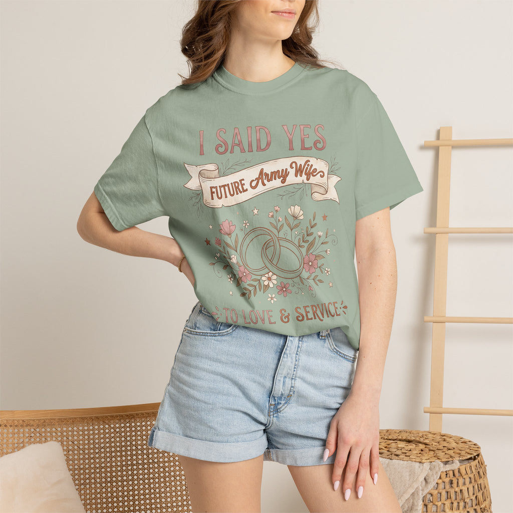 Light green T-shirt worn by a model, featuring front floral ribbon text graphic.