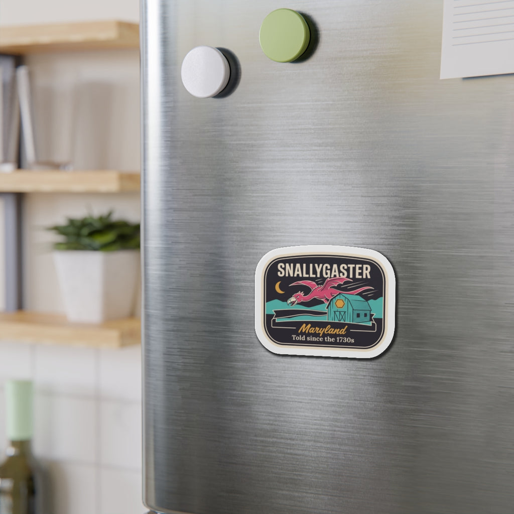 Snallygaster die-cut magnet on stainless refrigerator, rounded square with house and dragon art.