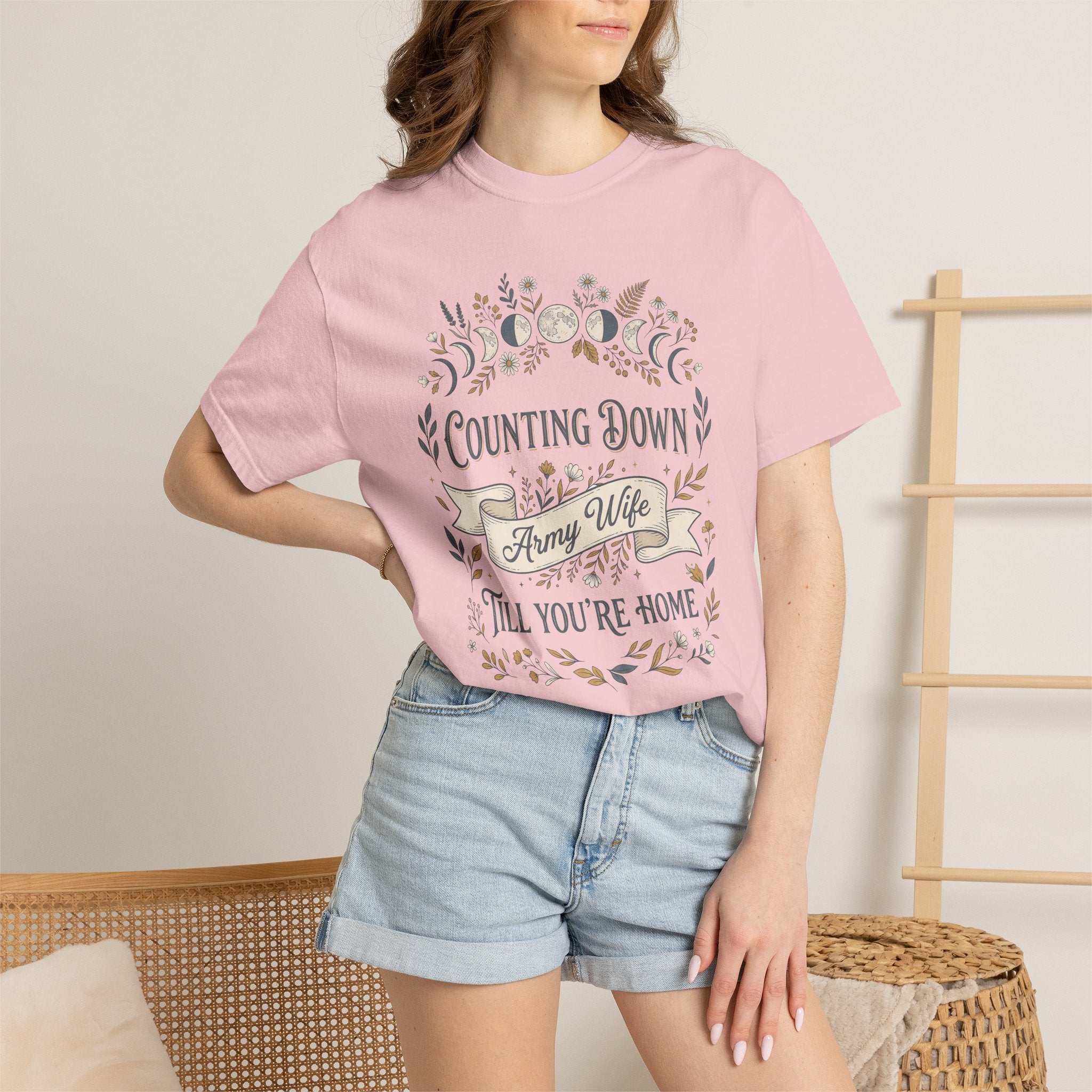 Light pink T-shirt worn by model with floral “Counting Down,” “Army Wife,” and “Till You’re Home”